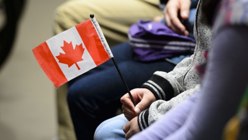 New young Canadian holding flag